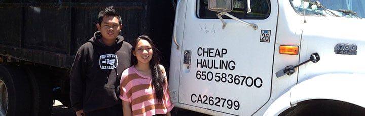 Robbie's Bay Area Hauling crew standing next to their white hauling truck